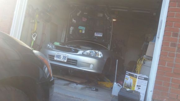 Getting ready to drop the engine out of the buttom,  my crane is currently stuck behind the car anyways :p.