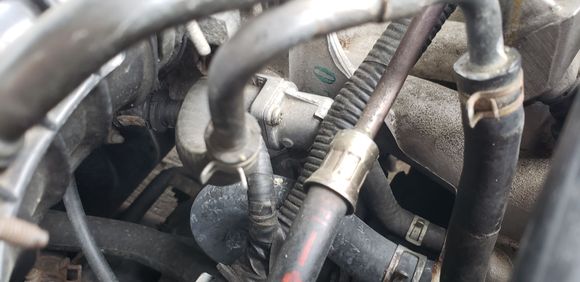This is the idle air control valve, has 2 screws on the backplate that can be removed and the valve can be tightened with a flat head screwdriver