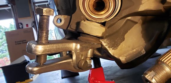 Used a ball joint separator to push the sleeve off.