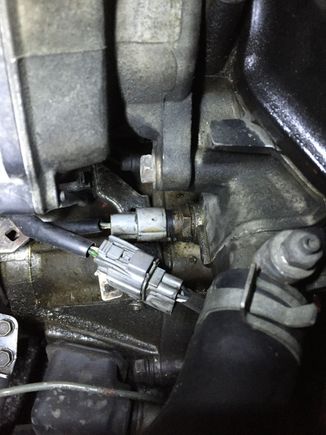 I don't know what that is, but it looks like there's oil coming out of it, and pooling under it. It's the round plug under the O2 sensor plug.