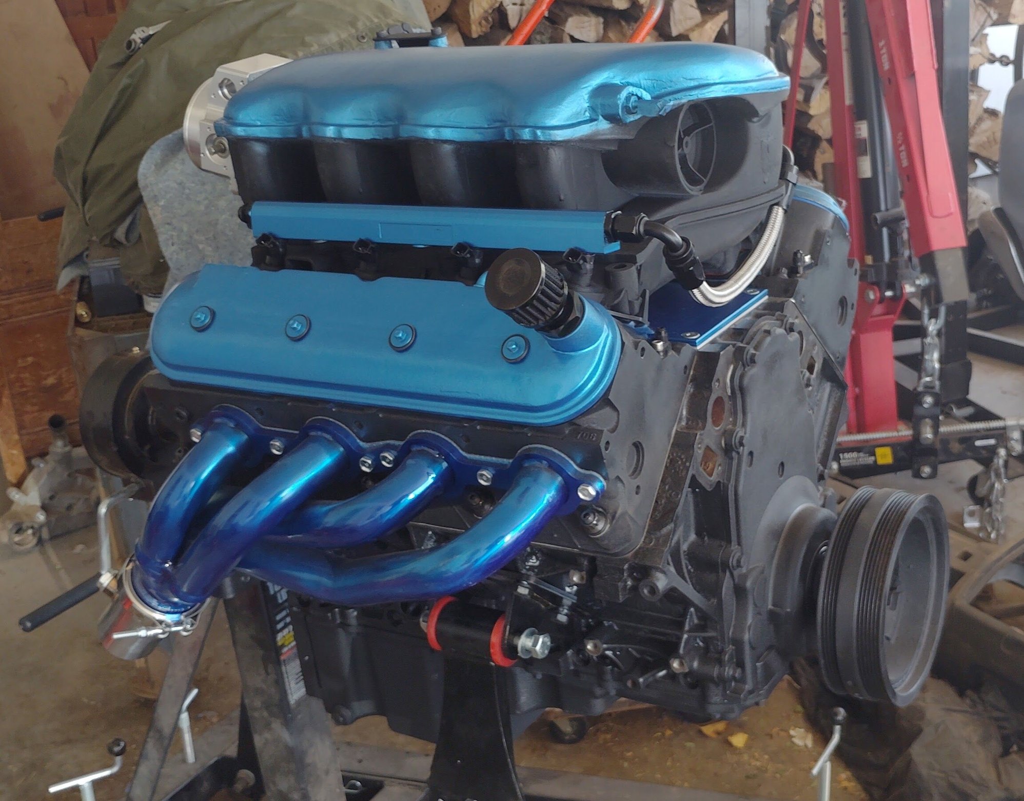 A nice, new engine. Well, used 6.0 iron block bored out to 6.2. All new internals except crank and rods (original). 706 heads (unshrouded valves), 600 lift, short duration cam, flat top pistons, 12.5:1 compression. Powerband idle to 6000rpm with peak torque around 3,500rpm  and peak horsepower around 4,000rpm. On paper it specs to around 550hp and about 580 torque. No dyno around here so true numbers I won't know. My numbers are based on formulas for the parts used. 