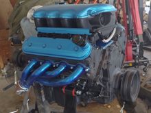 A nice, new engine. Well, used 6.0 iron block bored out to 6.2. All new internals except crank and rods (original). 706 heads (unshrouded valves), 600 lift, short duration cam, flat top pistons, 12.5:1 compression. Powerband idle to 6000rpm with peak torque around 3,500rpm  and peak horsepower around 4,000rpm. On paper it specs to around 550hp and about 580 torque. No dyno around here so true numbers I won't know. My numbers are based on formulas for the parts used. 