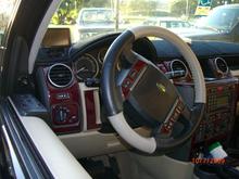 Interior enhancements include the WheelSkin Two-Toned Perferated Leather Lace-up Steering Wheel cover.  Makes a nice fat, soft grip.  eBay's Dashtrim Kit in Magma Burl for looks.  Garmin's Nuvi 755-T GPS guides me along the way, and I use a Parrot Bluetooth, since my LR3 didn't come with BT or NAV.  Dashmat's Signature Series Dash Mat protects the dash from UV rays and looks good too.  A Blend-Mount on the rear-view mirror holds my Passport Radar Detector for when I drive &quot;Out-of-state&quot;, as detectors are illegal in Virginia.

Plan on seeing a ScanGuageII mounted some where in that pic in the near future.  It's a 3-in-One unit, with Guages, Code Scanner, and Trip Computer.  Had one in my Tundra and loved it.