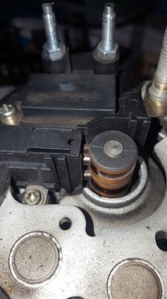 Notice that there are two brushes and they both have holes in them. These brushes are spring loaded and the holes line up with the hole at the top; when they are pressed inwards.