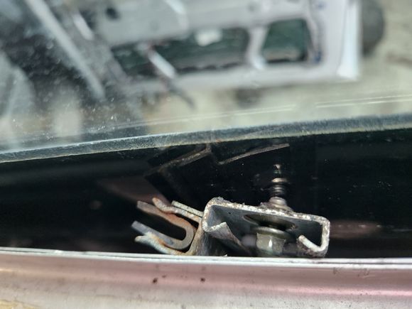 Right rear, regulator flipped and jammed between glass and door, holding up glass 😬