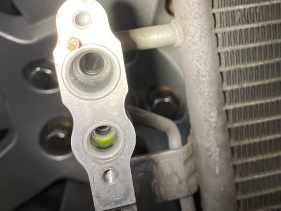 This looks like compelling evidence for replacing the condenser coil with a failed compressor.  The condenser is full of compressor metal from the inlet.  It’s also good to see that it’s clean coming out so that contamination is not getting to the evap coils.