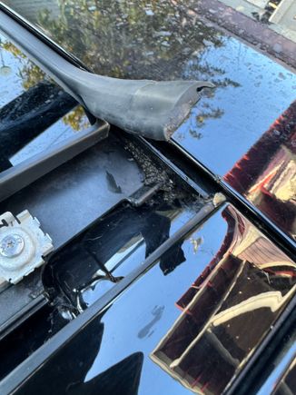 When you are done cleaning the drain channels - also look under the front corners - under the rubber weatherstrip - it just pulls up. All sorts of gook under there.  I believe this is important as it is likely where the secondary drain holes up front are -- somewhere under there. 