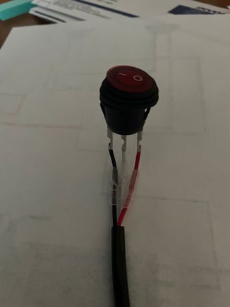 Nilights illuminated rocker switch, to be replaced by Discovery CC switch. It has 3 wires, red, white and black.  Red and white are connected when the switch is activated.