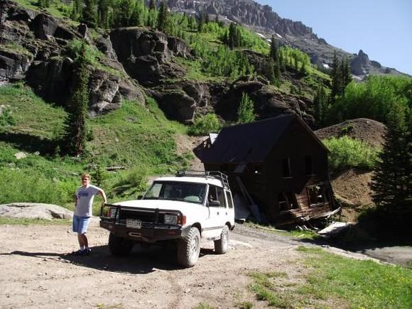 SanJuanPicsJuly22011.  Old mine building leaning precariously in the old Sneffels town area up Yankee Boy Basin above Ouray.  The wife is gripping the Rover so it does not turn turtle and roll down the slope.