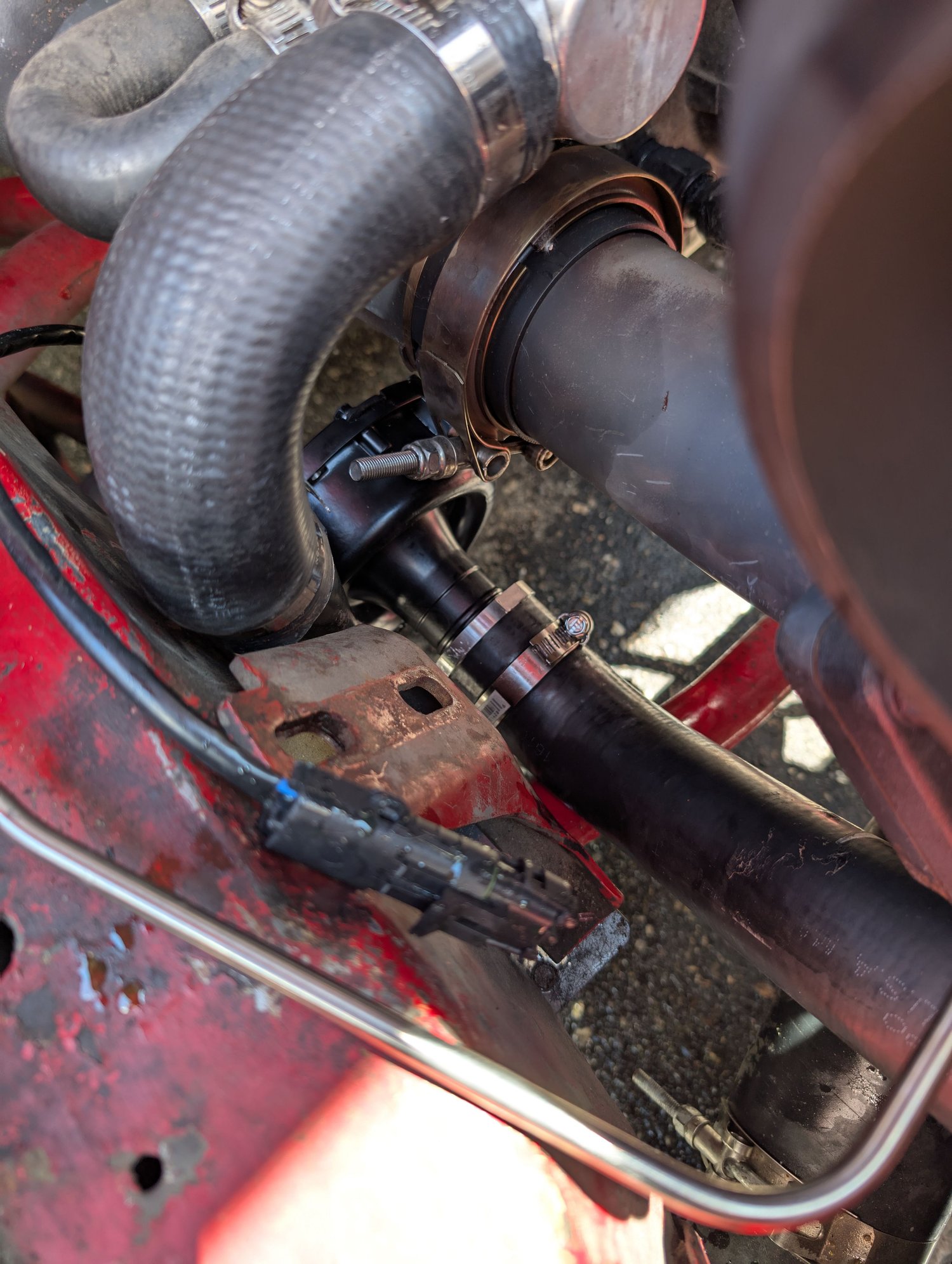 There it is tucked down there nicely. I was able to cut my existing lower hose for the top connection then needed to raid a parts stores hose stash to get from the radiator to the pump. I needed a Z shaped hose and luckily found one I could work with