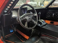 The interior was my job.  Mark let me do what I wanted.  From carpet to headliner.  The center console is made of mdf.  The Holley Dash has a 3D printed surround with a black vinyl wrap and carbon fiber trim.  The Shifter knob is a 3D printed test piece that's now permanent.  We used the TrailBlaze steering wheel.  The buttons on the wheel control a custom heater/defroster.  The wiper controls work too.  A custom BCM was made using an Arduino to control the wipers and the heater.  