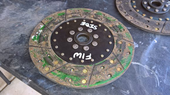 It turns out that the green protective coating, which Fidanza tells you will wear off normally, it actually melted to the clutch disk. This explains why I could not shift into gear with the engine running. The two were fused together.