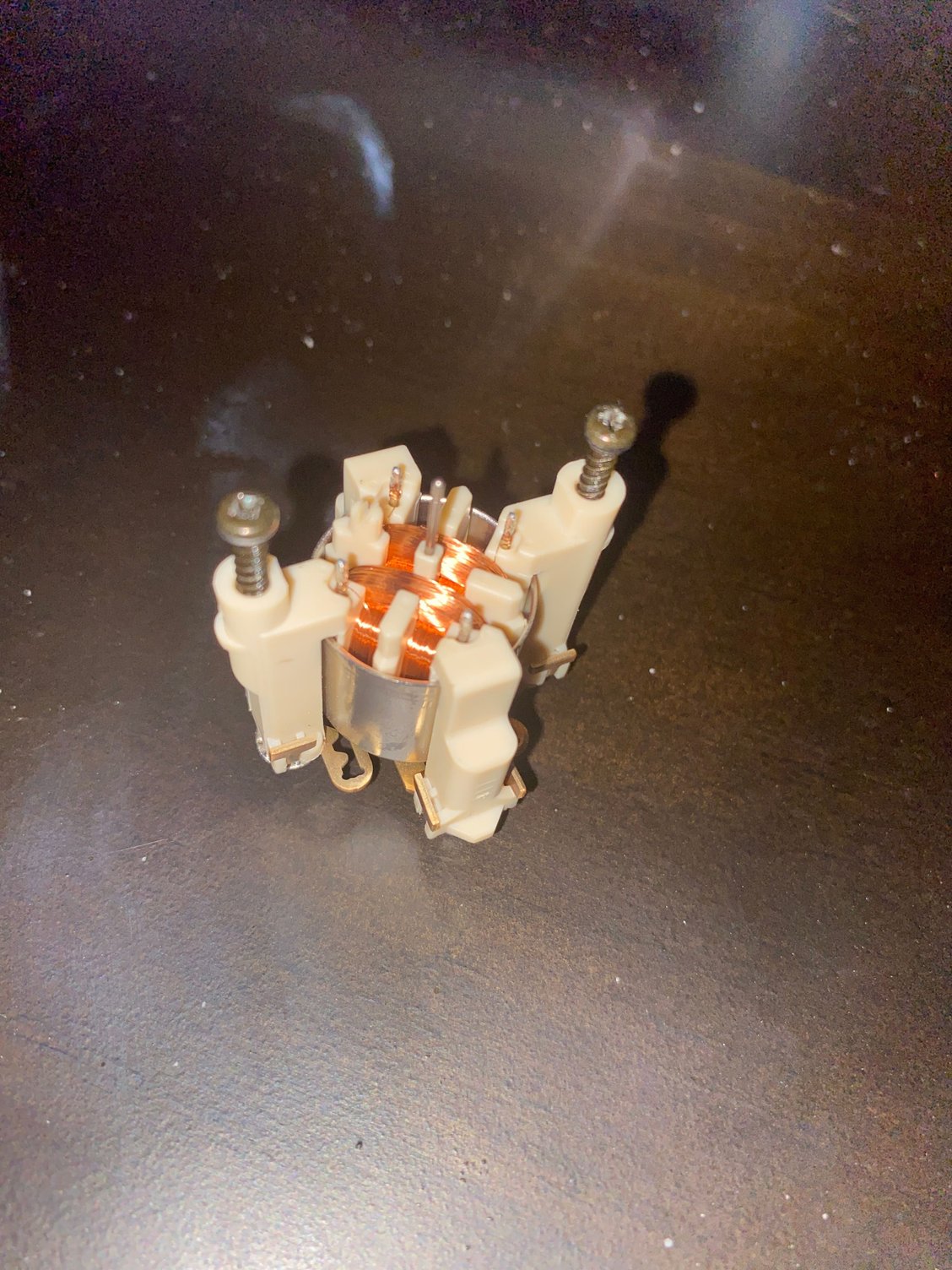 This is the tachometer stepper motor. The middle shaft broke out, the one that came out is in my current cluster in my car. (This is a spare not the issued one) 