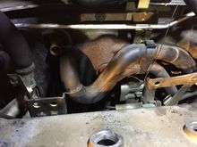 2 on the left and 2 on the middle. You can see I removed the coolant hose and bent the high pressure power steering bracket to access the bolts. Thanks Nissan!!