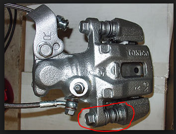 bolt is tight, but bushing or something is loose unless braking pressure is applied