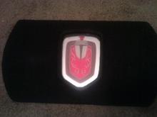 Layered knight's crest on spare tire piece. Lights up between logo and silver border