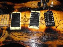 Seymour Duncan AHB-1 blackout pickups, two volume, two tone, and a stratocaster style tremelo bridge.