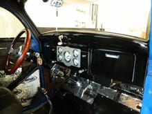 Lets see, Grant banjo steering wheel, Stewart Warner gauges in a custom panel made for my by a friend at FedEx, Moon tach, Hurst ProMatic II shifter, a Vintage Air hvac hanging just below and in the glove box, a/c controls, Kenwood stereo and an aux power port. What we used to call a cigarette lighter...