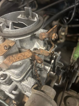 Am I missing a spring on the top of my carb.  The butterfly seems to stay open.  Looks like a hole on the linkage on the top right 