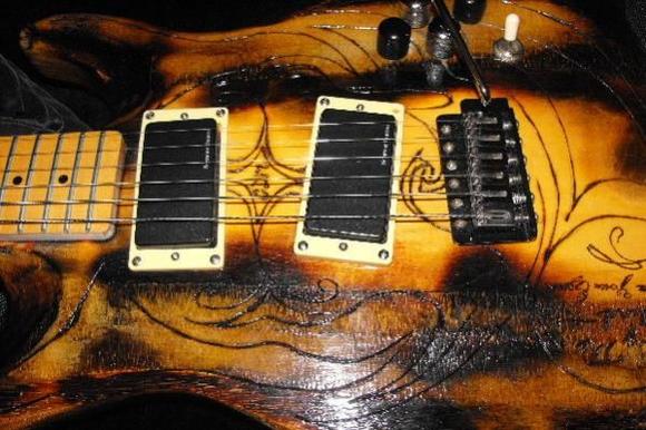Seymour Duncan AHB-1 blackout pickups, two volume, two tone, and a stratocaster style tremelo bridge.