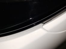 See the plastic looking edge right before the painted bumper meets the headlamp.