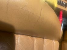 These cracks are a result of improperly feed leather. Most consider this Ok I would not. My seats don't have these cracks as I have always feed the leather and not wiped on a protectant like Griots leather scented wipes or 303. 