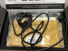 The cord for programming comes with it. I had this plugged in so all I needed to do if I wanted to change the suspension map was pull packing tray carpet up and then pull out the cable. No need to remove the DSC or sit in the tiny back seat. 