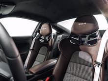 911 R seats in brown (forget the name of the brown) leather with black/silver houndstooth and standard platinum silver stitching.