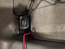 The cable can be routed out from the under the carpeted floor.