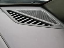 Dash speaker grilles wrapped in leather with deviated stitching. 