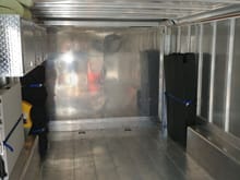Rear of the trailer.  Ramps, chairs, canopy mounted to the wall.  Table and mount added recently.