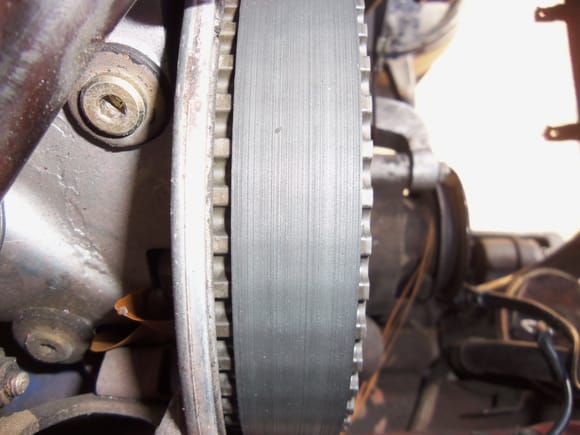 For reference:  this is the tracking on the passenger's side sprocket with the old belt and misaligned tensioner roller.