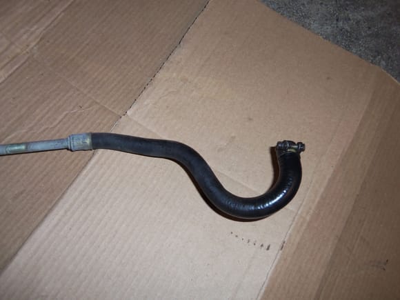 Reservoir end of the PS return line assembly. This rubber hose is commonly replaced with bulk hydraulic hose.