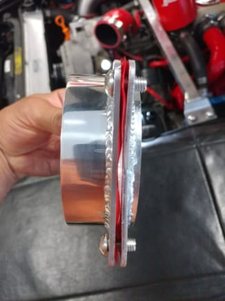 To the left is the inlet flange that the silicone hose that feeds the airbox connects to. To the right is the shortened flange that sits in the fender hole.