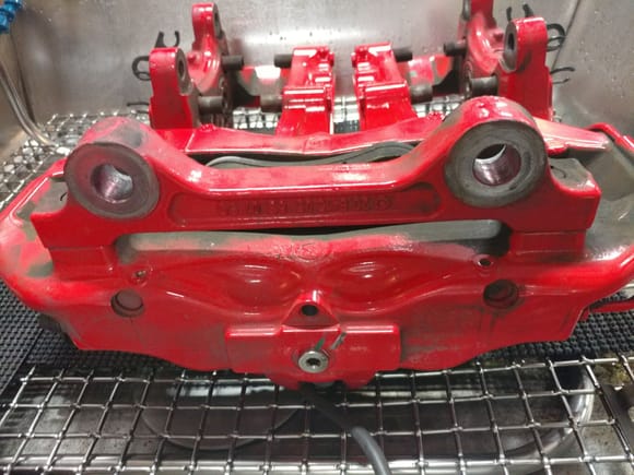 Threaded plug sealing caliper so no cleaning solution could enter the caliper. Note calipers placed on rubber pads to not mar the finish from the ultrasonic action
