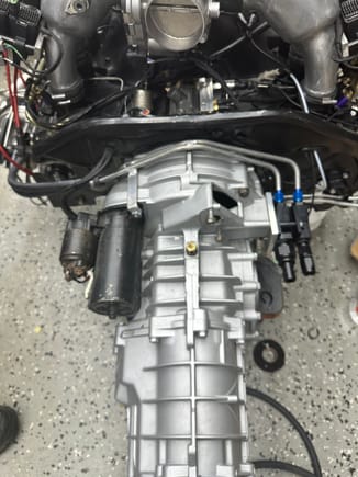 Main coolant lines are mounted over the port for the clutch access. It will be work to separate once dropped but better for R&I. These will connect to hoses to the pump and radiator located behind the secondary oil cooler. I used a 964 tip cooler to cool the turbos. 