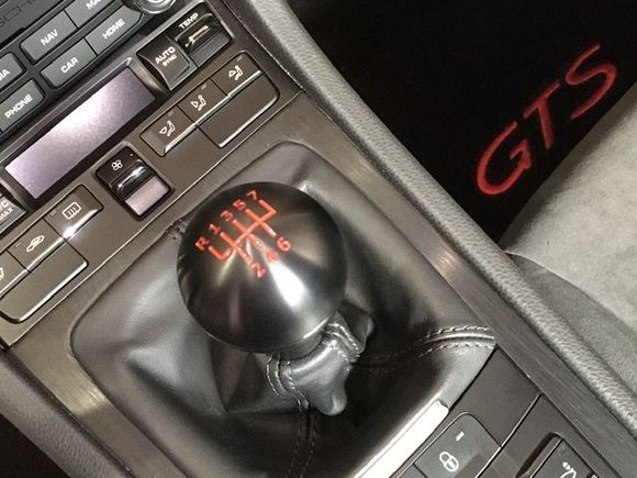 F1 shift knob and Lloyd mats. Both add a bit of color, along with Guards Red seatbelts, to an otherwise dark interior. 