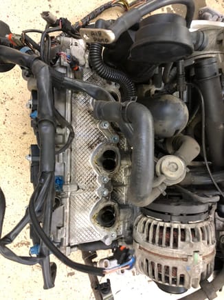 
1. Remove passenger side intake manifold (~6 bolts), disconnect fuel rail by removing injector clips, electrical connectors, 2 bolts and swing to side. Also a small electrical connector at the rear you need to unplug/unscrew.