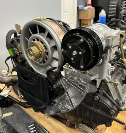 And here is the new compressor on the freshly re-done mount. I'm planning to use a different block to connect the lines, running modern barrier hose behind rather than above the intercooler/airbox. Should be a neater and less leaky solution for R134a.