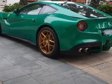 Green Ferrari F12 Berlinetta on gold wheels. 