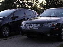 My Nissan next to my girl's 2012 Ford Fiesta.