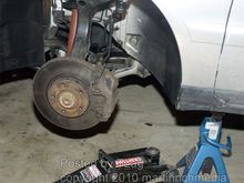 Remove the wheel, and use a jackstand.