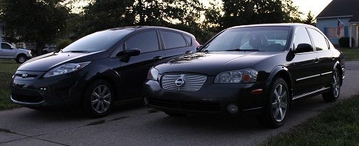 My Nissan next to my girl's 2012 Ford Fiesta.
