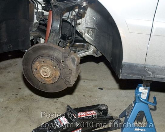 Remove the wheel, and use a jackstand.