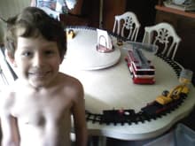 My son, 8; boy train=perfect happiness
His head is not that big in real life :)