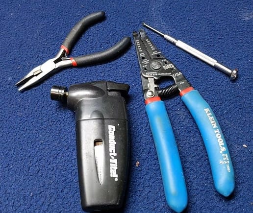 Needle nose pliers, jewelers screwdriver, miniature butane torch, small gauge wire strippers.