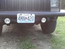 closer pic. funny plate number eh? didn't ask fer em like that. oh, and i used truck bedliner to redo the flat black i painted the grill, and did it to the bumper. next i might do around the head lights.