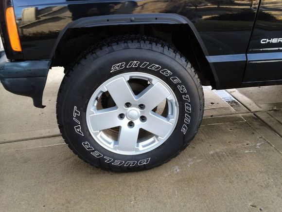 I trimmed the wheel wells according to the directions for some Bushwacker Fender Flares.  Sooner or later I'll get around to purchasing some.  I painted the trimmed area with some bedliner from Harbor Freight.  It's held out really well and I like the matt look.  May be a sign of things to come...
Not a lot of clearance with the new shoes however...