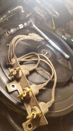 2nd round, these wires melted on driver side, near air cleaner. yellow pieces attach to vacuum lines. not sure what this whole thing is? connects to pigtail that had a red/white wire, potentially same red/white wire as from 1st melted green wire?