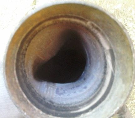 Inside view of down pipe with two factory pinches blocking exhaust flow.
